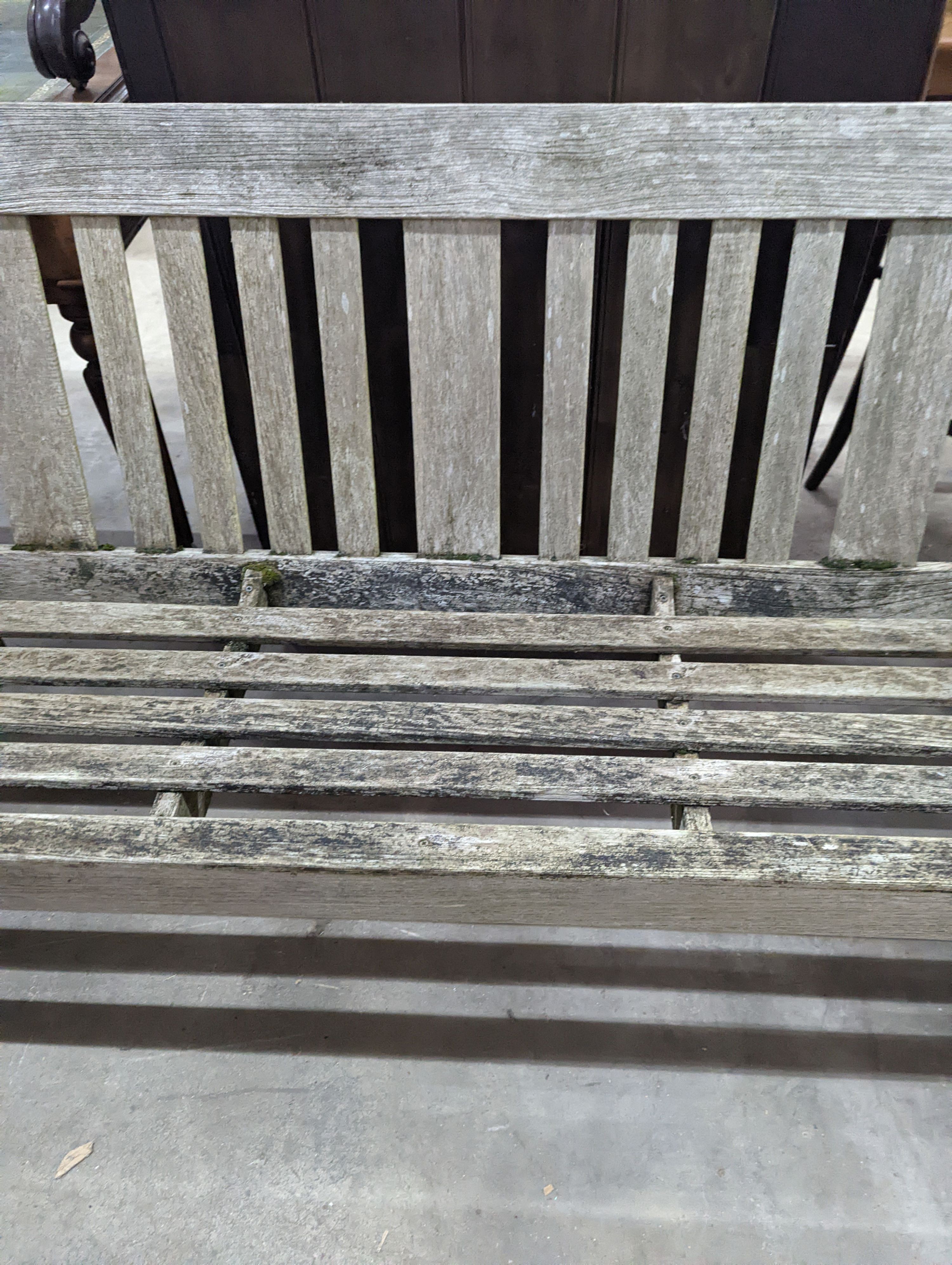 A weathered teak garden bench, length 158cm, depth 62cm, height 84cm